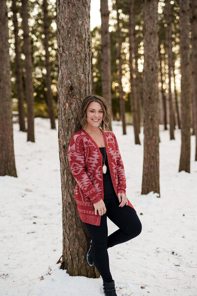 Jen Heller in the woods in a red sweater