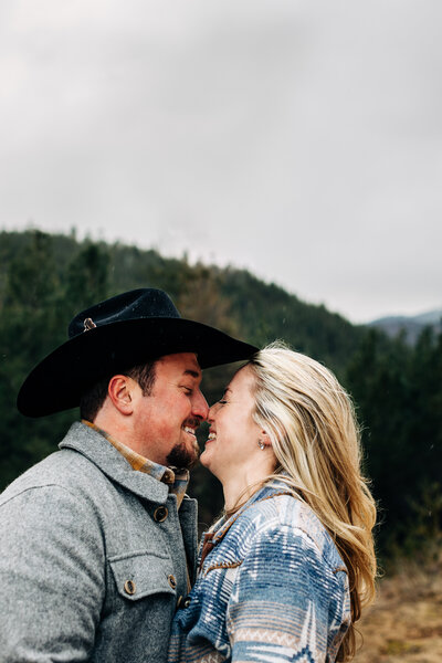 Adventure Engagement Photos in the Snowy Mountains with cowboy hat