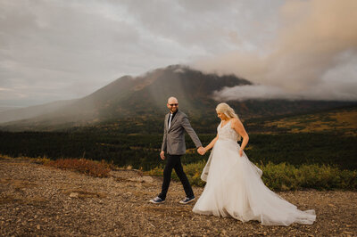 couple walking in front of mountain