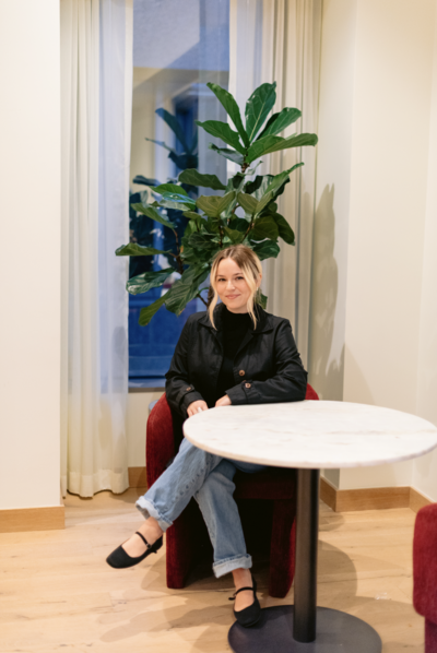 Therapist in Raleigh for stress sitting smiling at camera