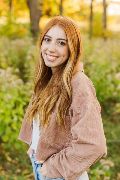 Senior Picture smiling facing the camera at golden hour in Minooka Park Waukesha.  Waukesha Photographer.