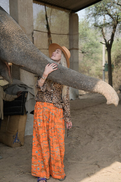 Alexis Stein standing with an elephant