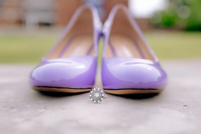 Close-up of Tarleton State senior ring in front of purple heels during senior session on campus in Stephenville, Texas.