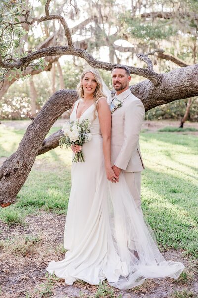 Couple elopes with bright tropical colors on the beach in Treasure Island, FL