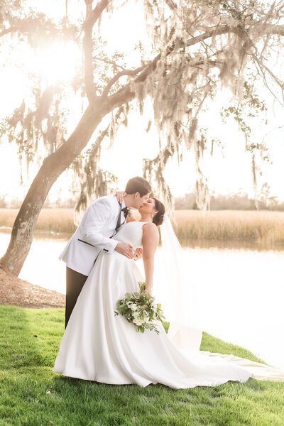 bride and groom portrait on the waterfront of the caledonia golf and fish club in pawley's island south carolina