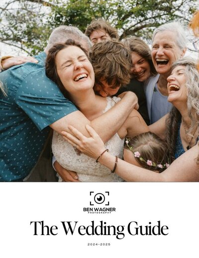 Bride is surrounded by wedding guests in a group hug