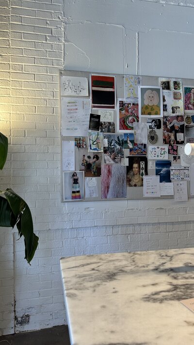 Design concept mood board on white brick wall.