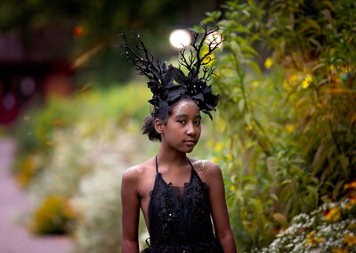 African girl with blackk gown and antler head piece