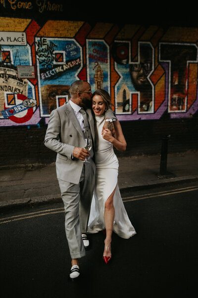 Bride and Groom in front of the Brixton mural in London. 