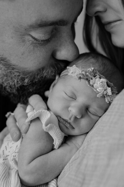 Dad kissing his newborn daughter. Maternity photographers nj, New Jersey Family photographers