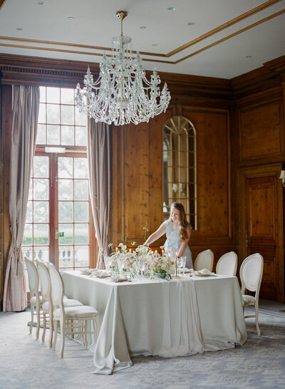 Willow and Oak Events setting the table for a ballroom wedding reception in England