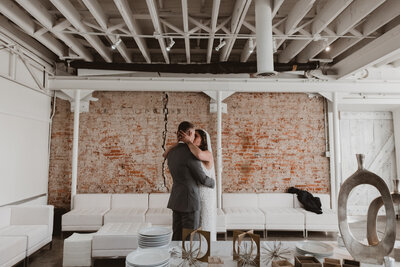 Bride and Groom walk down the aisle with a dusty blue, sage, and white bouquet at the St. Julien Hotel in Boulder, Colorado.