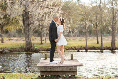 Couple outside on wedding day sharing a kiss