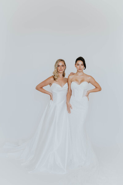 bride looking in mirror while trying on dress