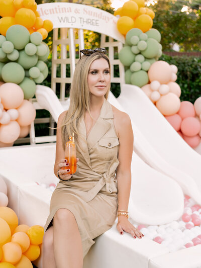 Elegant outdoor celebration with pastel balloon decor and a chic, modern vibe