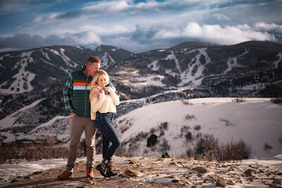 Couple hugging each other on a mountain top