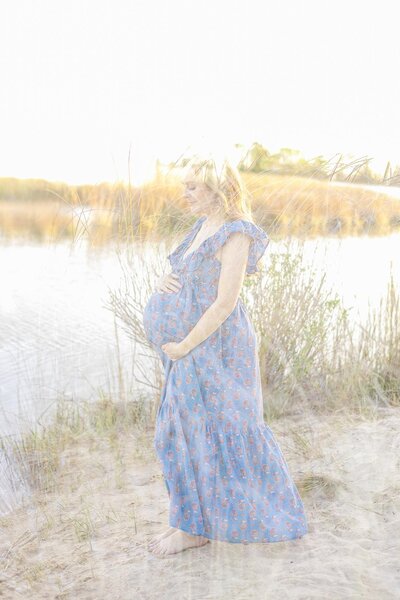 Virginia Beach Maternity PhotProfile  Portrait of a pregnant woman standing by the water with the beach grasses by Mary Eleanor