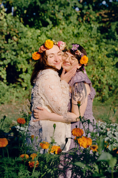 Portrait of queer couple together right after they eloped in a flower field - film wedding photographer at Castillo Holliday Photo + Film