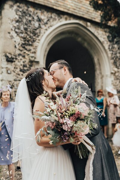 Wedding couple, confetti and bouquet