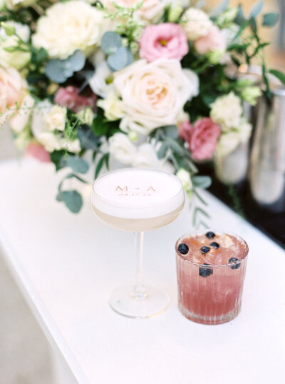 Two signature cocktails on the bar at a wedding reception