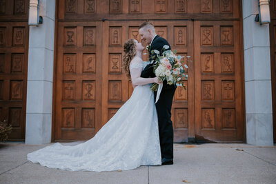 Destination wedding photographer captures couple embracing in front of a Nashville church