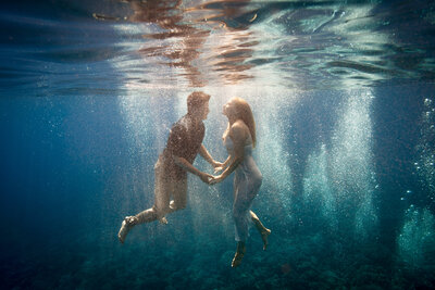 bride and groom celebrate underwater on Maui 
