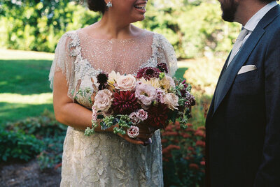 Bride holding her bouquet at her wedding at Dye House in Providence, Rhode Island. Photography by Rhode Tripper Photography