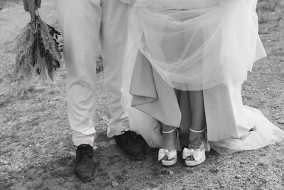 detail photo of bride and groom wedding shoes