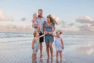 Family gets their photos taken at sunrise on the beach in Indian Rocks, FL