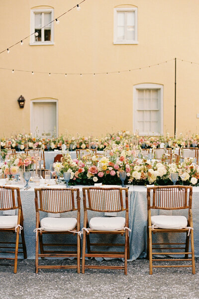 Details of the wedding reception with pastel flowers and blue tablecloths in Charleston SC at William Aiken House