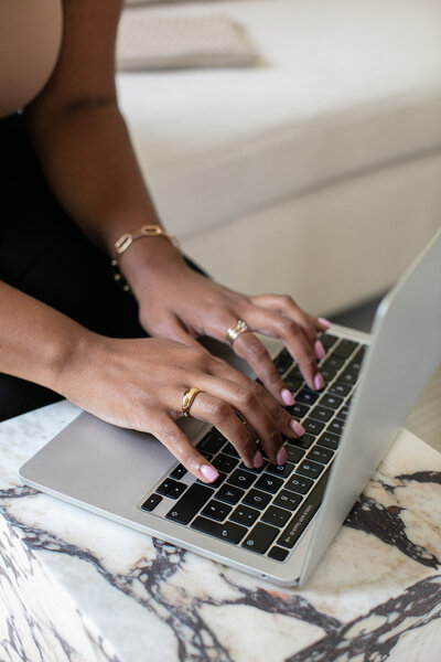 image of woman on a laptop on a website for therapy and coaching for moms of color