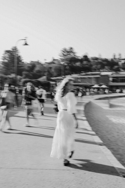 Blurry image of a woman walking along a promenade