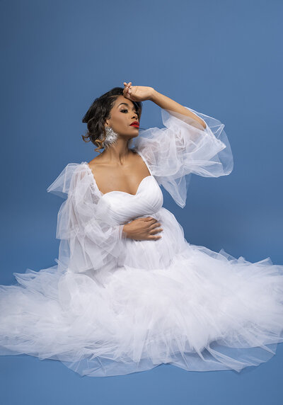 Couple holds sign announcing baby boy in maternity photos