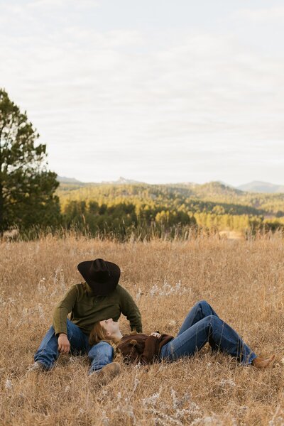 Jordan looking down at Emma as she lies her head on his leg.
