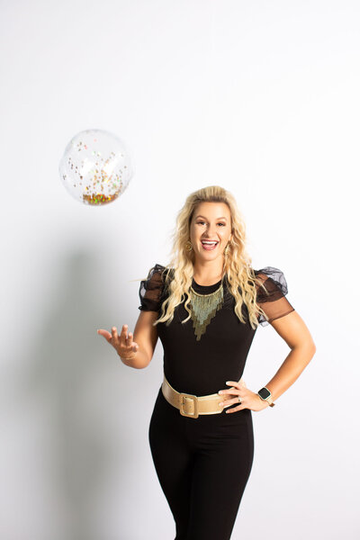 Amy smiling while holding a balloon