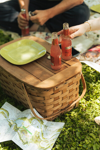 a picnic basket, drinks, and map during an upstate new york elopement day