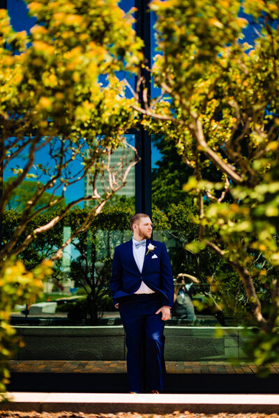 A groom standing in front of the fifth third building in downtown toledo ohio