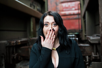 Girl covering her face with her hand in surprise