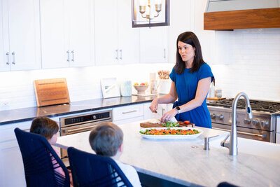Jess talking to and feeding her kids in the kitchen