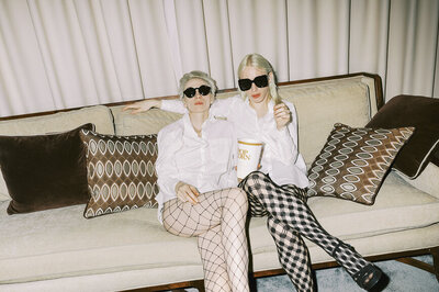 two people on couch with pattern tights