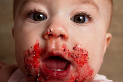 After a Minot, ND cake smash session, this little girl got close to the camera and smiled.