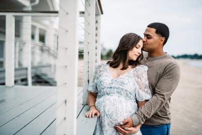 Capture the beauty of pregnancy with a romantic beachfront maternity session in Connecticut. This intimate photo showcases a loving couple embracing by the shore, celebrating their journey to parenthood. Book your stunning maternity photoshoot with Nicole Mele Photography and create timeless memories by the ocean.