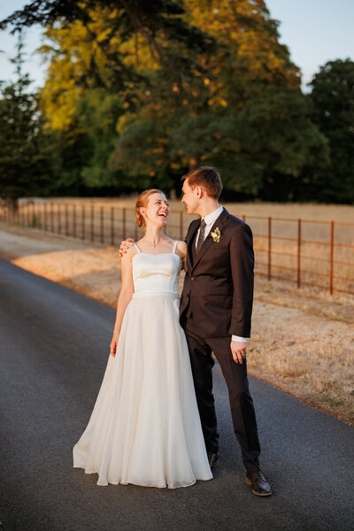 Couple laughing at Sunset at Wasing Park on their wedding day