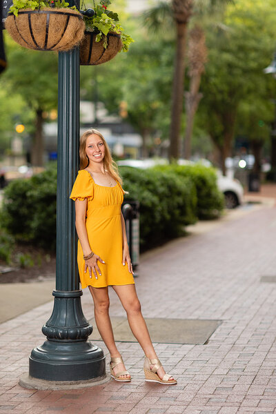 A girl taking her senior portrait in downtown Columbia, South Carolina