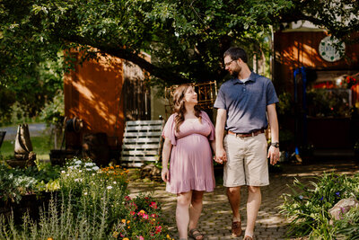 mom to be with dad's arms wrapped around her