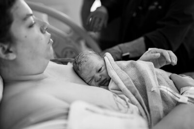 Newborn son resting on mom's chest and taking in first moments at a Charleston area hospital birth 