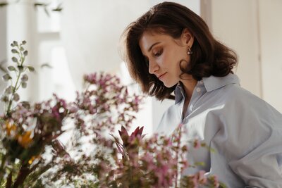 woman looking at flowers