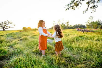 Sister photos in field golden hour