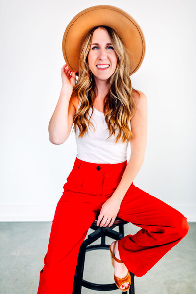 Woman wearing hat with red pants