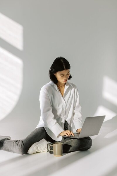 A Kmotion employee working on a laptop, a key part of Showit website design services.

